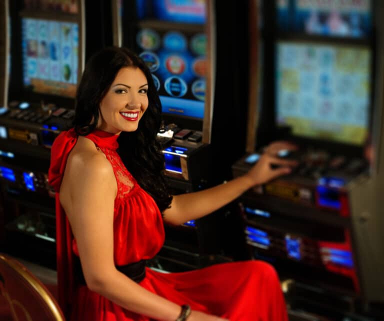 Lady in red dress playing on a slot machine