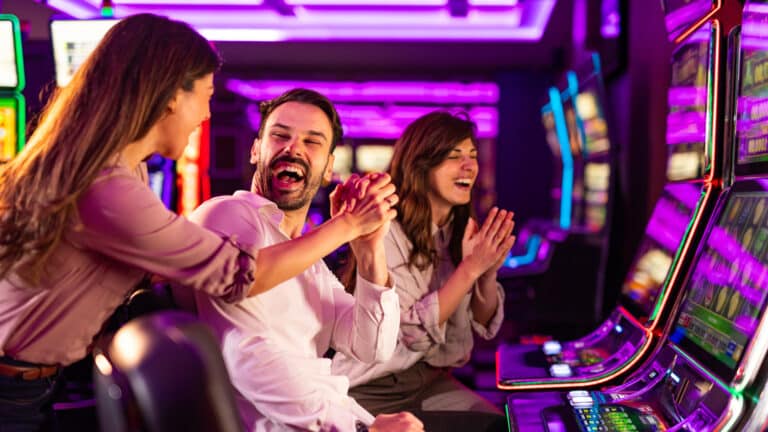 Group of friends having a blast playing slots